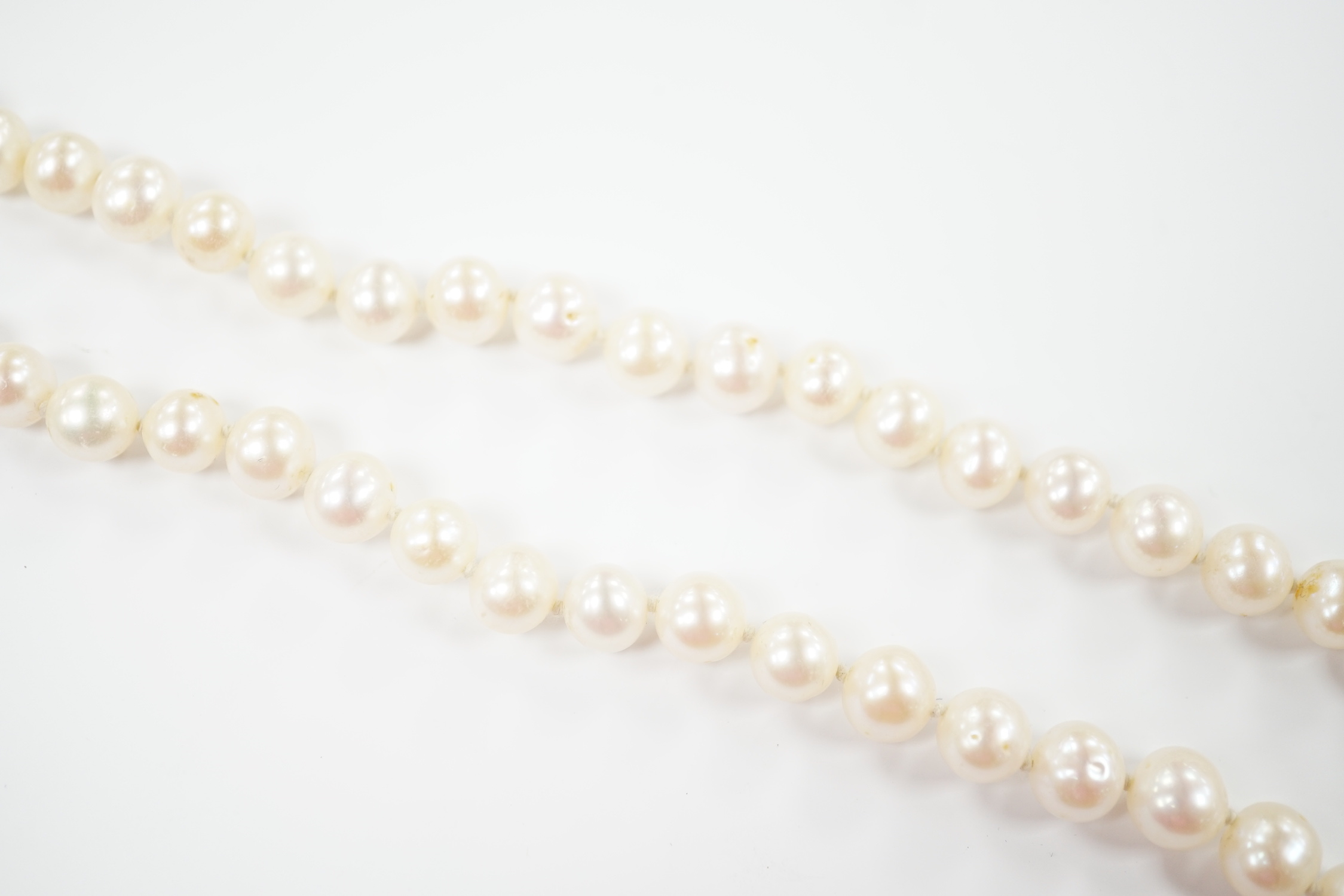 A single strand cultured pearl necklace with 18K and diamond chip set spherical clasp, 49cm.